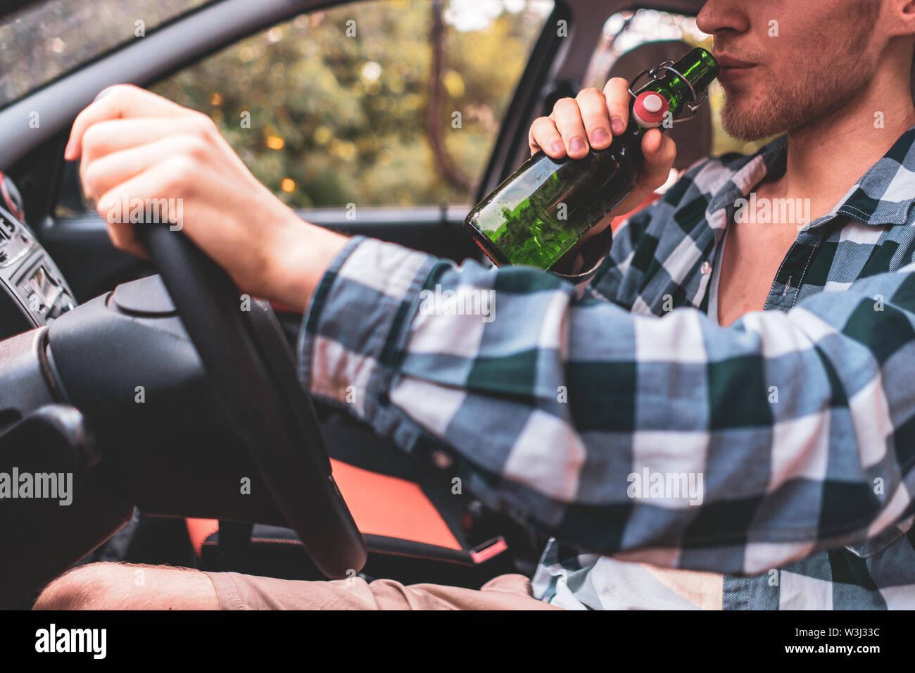 young crazy drunk man driving the car and drinking alcohol Stock Photo ...