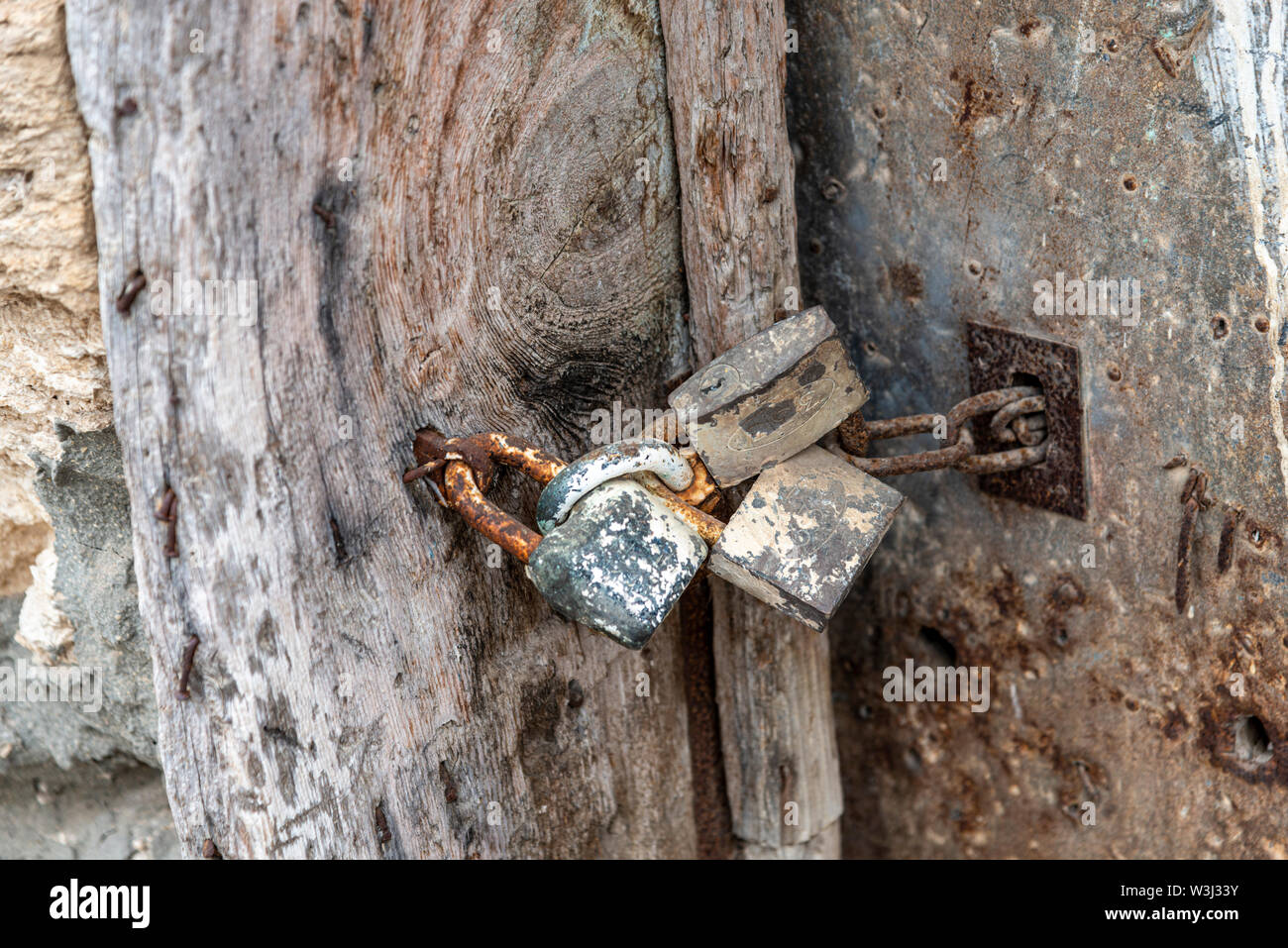 Locking door with old rusted locks Stock Photo Alamy