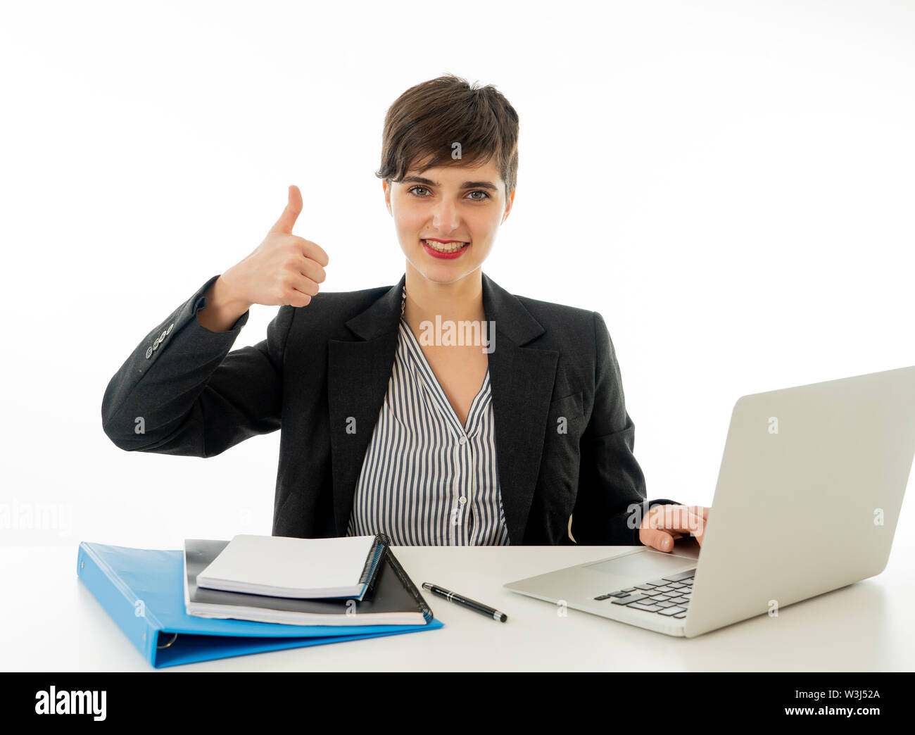 Happy, smiling and successful businesswoman working on computer laptop ...