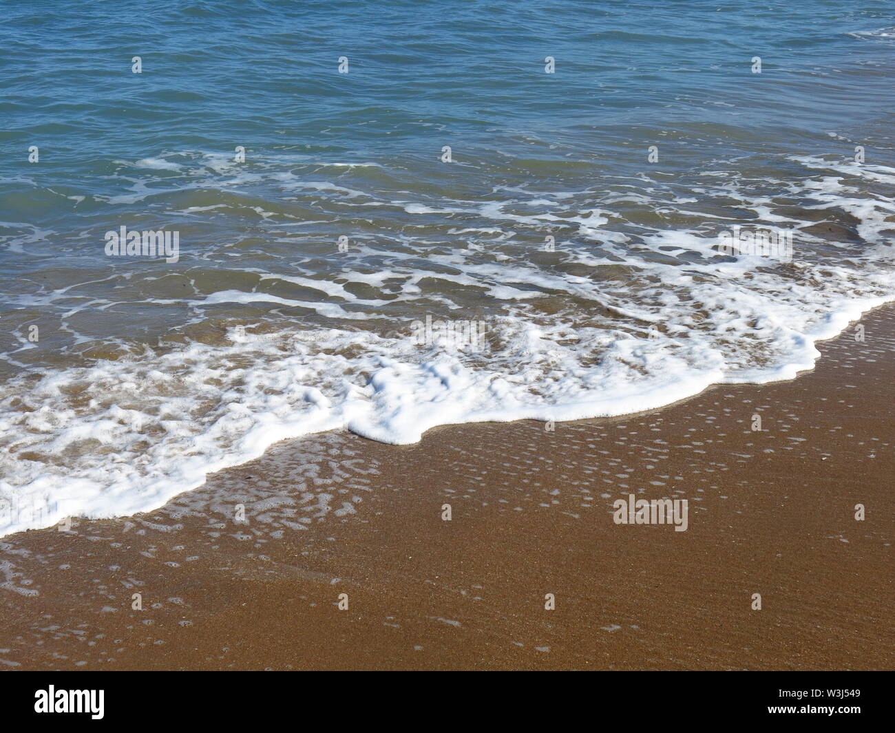 Mediteranean sea meets Les Marines beach in Denia. Stock Photo