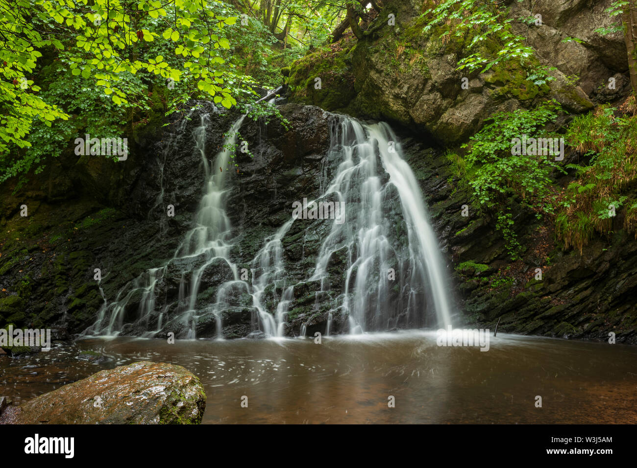 The falls at  Fairy Glen, a hidden jewel found after a 30-minute hike near the town of Rosemarkie, Scotland on the Black Isle Peninsula. Stock Photo