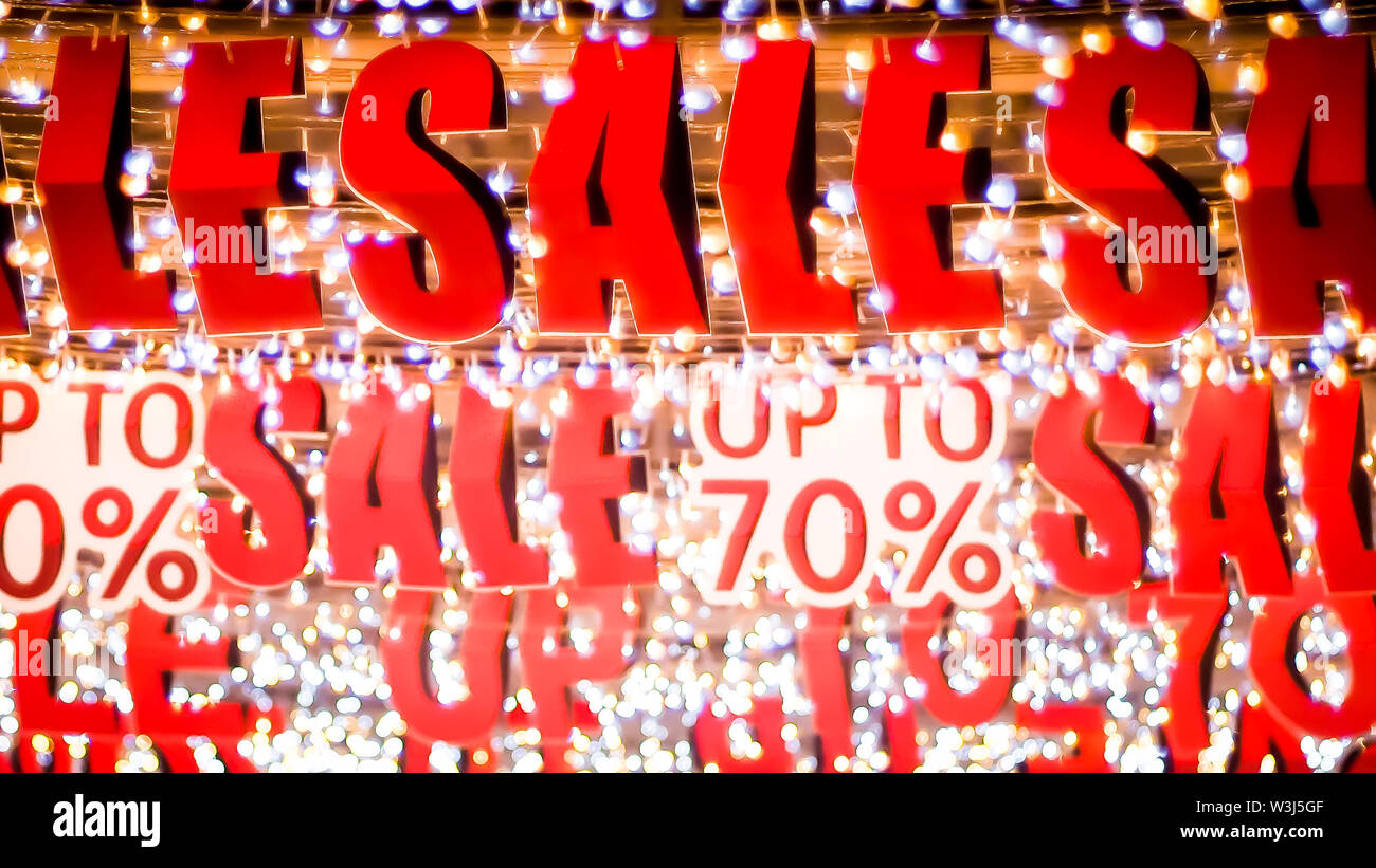 Store sale sign. Special offer banner with the red sale text gold bokeh blur background Stock Photo