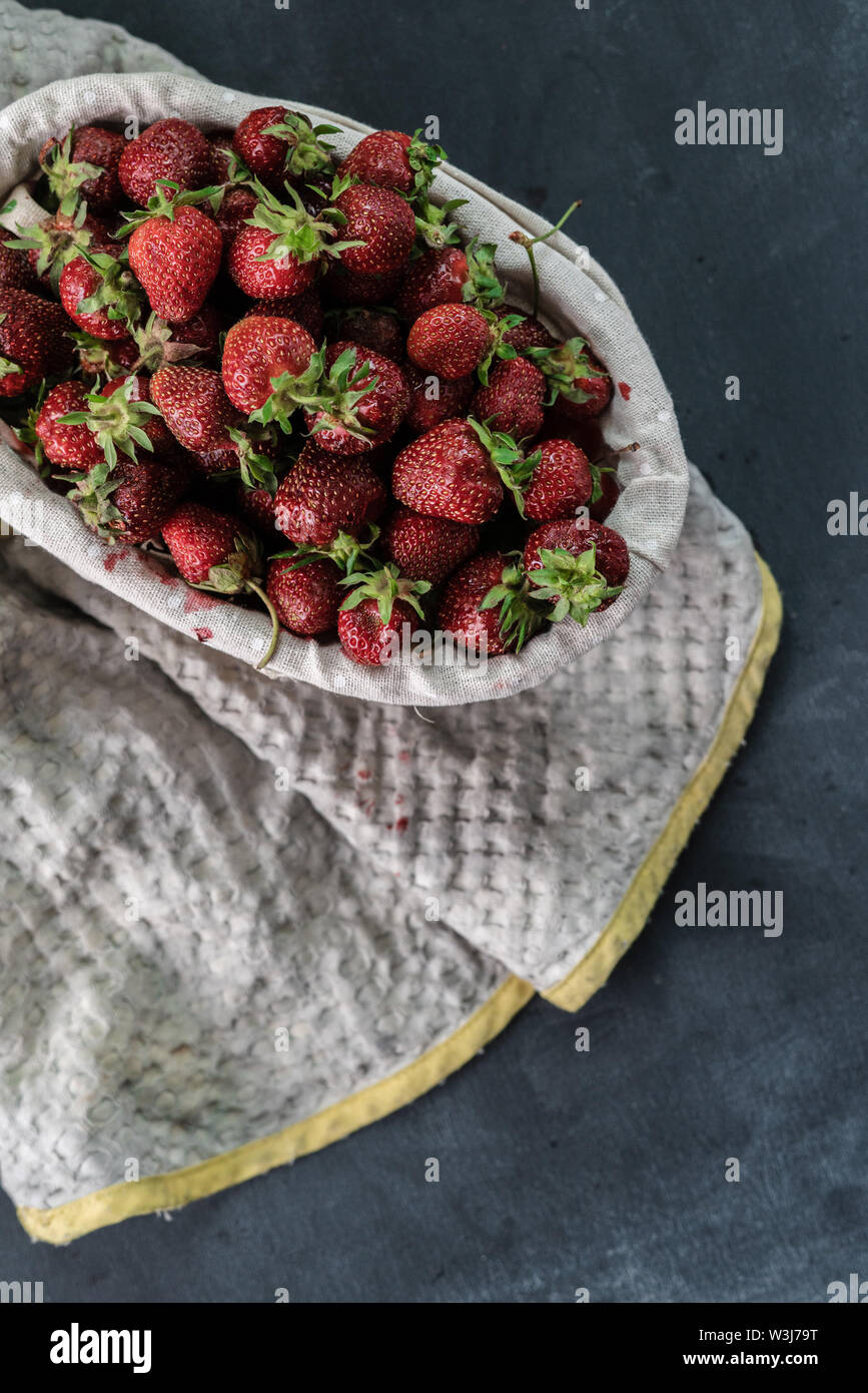 fresh raw strawberry in the tray, organic healthy food on dark ...