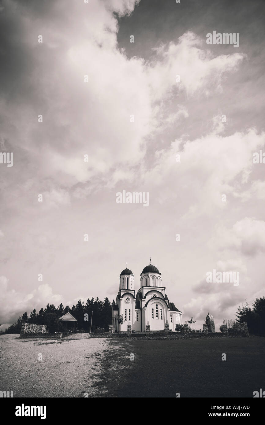 Exterior of a small Orthodox church on the hill in black and white. Stock Photo