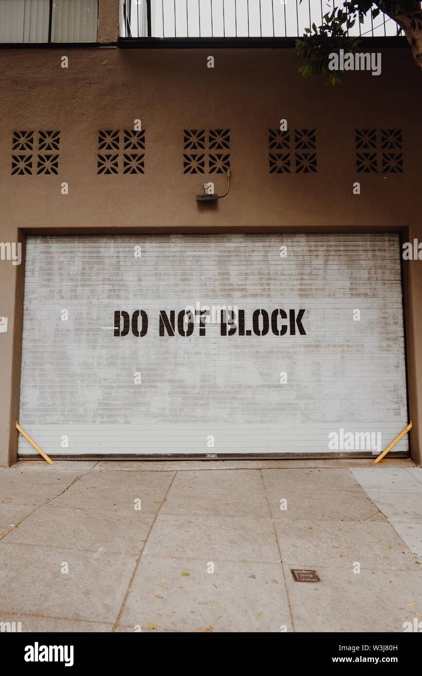 A Closeup Vertical Shot Of A Garage Door With Writing Do Not