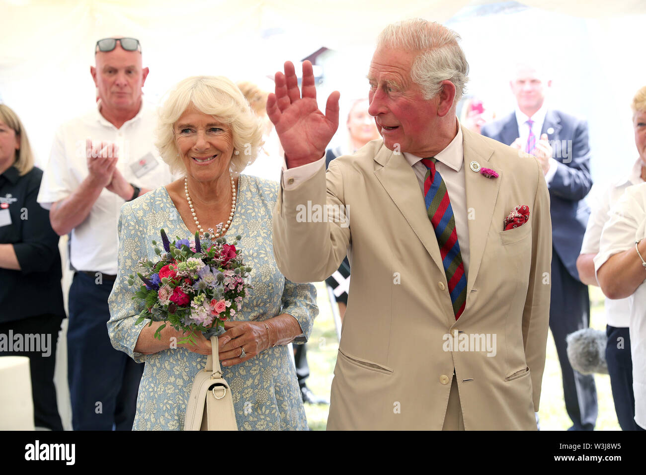 The Prince of Wales and the Duchess of Cornwall during a garden party to celebrate the 50th anniversary of Ginsters bakery in Callington, as part of their visit to Cornwall. Stock Photo