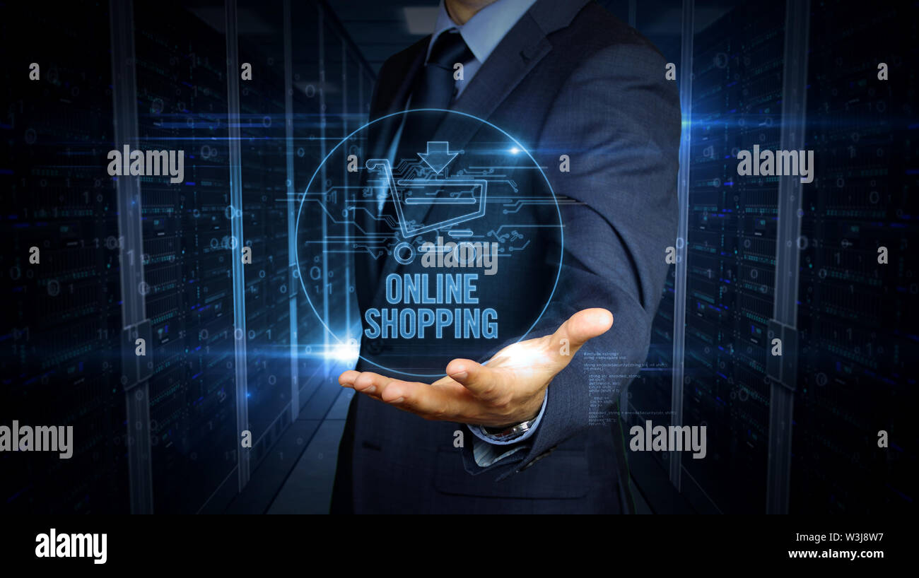 A businessman in a suit and the screen with cart hologram over hand. Man using and virtual display interface. Online shopping, internet business, netw Stock Photo