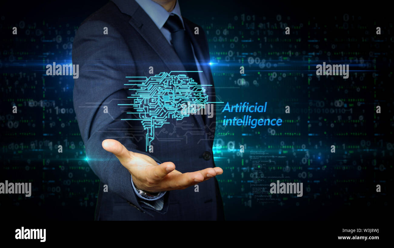 A businessman in a suit and the screen with cybernetic brain hologram. Man using hand on virtual display interface. Artificial intelligence, machine l Stock Photo