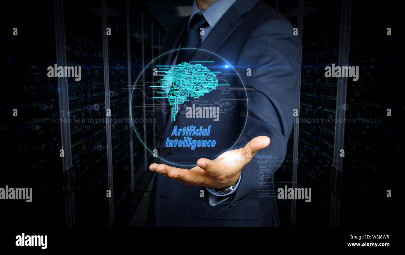 A businessman in a suit and the screen with cybernetic brain hologram. Man using hand on virtual display interface. Artificial intelligence, machine l Stock Photo