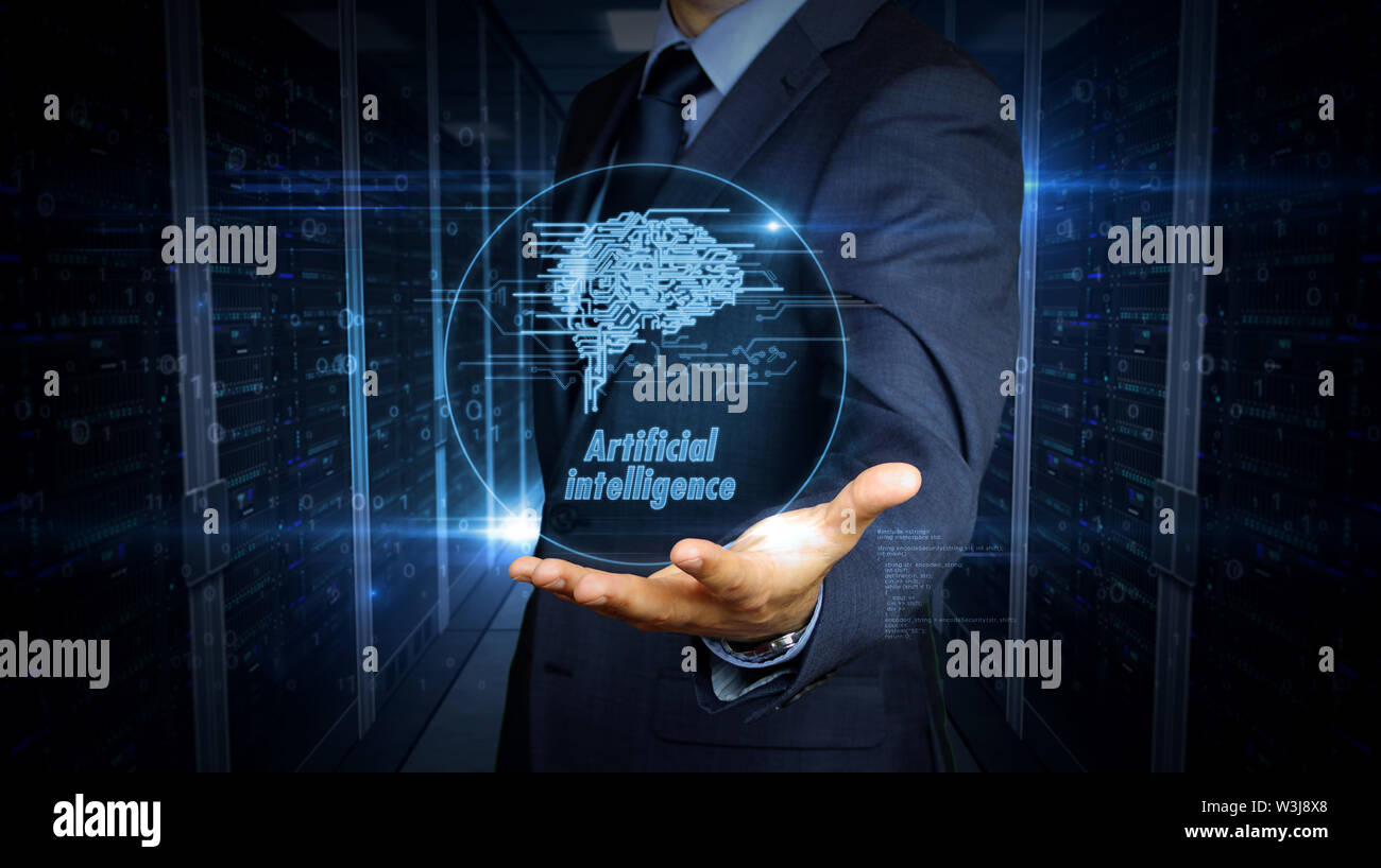 A businessman in a suit and the screen with cybernetic brain hologram. Man using hand on virtual display interface. Artificial intelligence, machine l Stock Photo