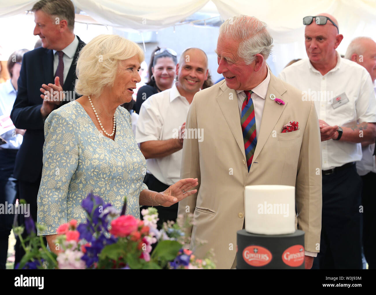 The Prince of Wales and the Duchess of Cornwall during a garden party to celebrate the 50th anniversary of Ginsters bakery in Callington, as part of their visit to Cornwall. Stock Photo