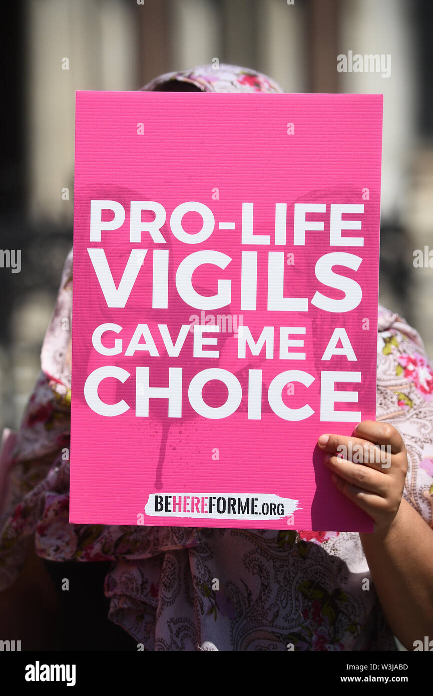 A woman, who was approached by Pro-Life vigils outside of abortion clinics in London, holds a placard outside the Court of Appeal, as an appeal against a ban on demonstrations outside a London abortion clinic is set to be heard. Stock Photo