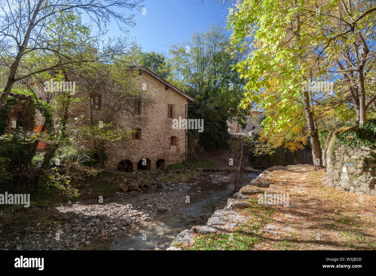 Sant Joan de les Abadesses, Catalonia, Spain. Old windmill close to river. Stock Photo