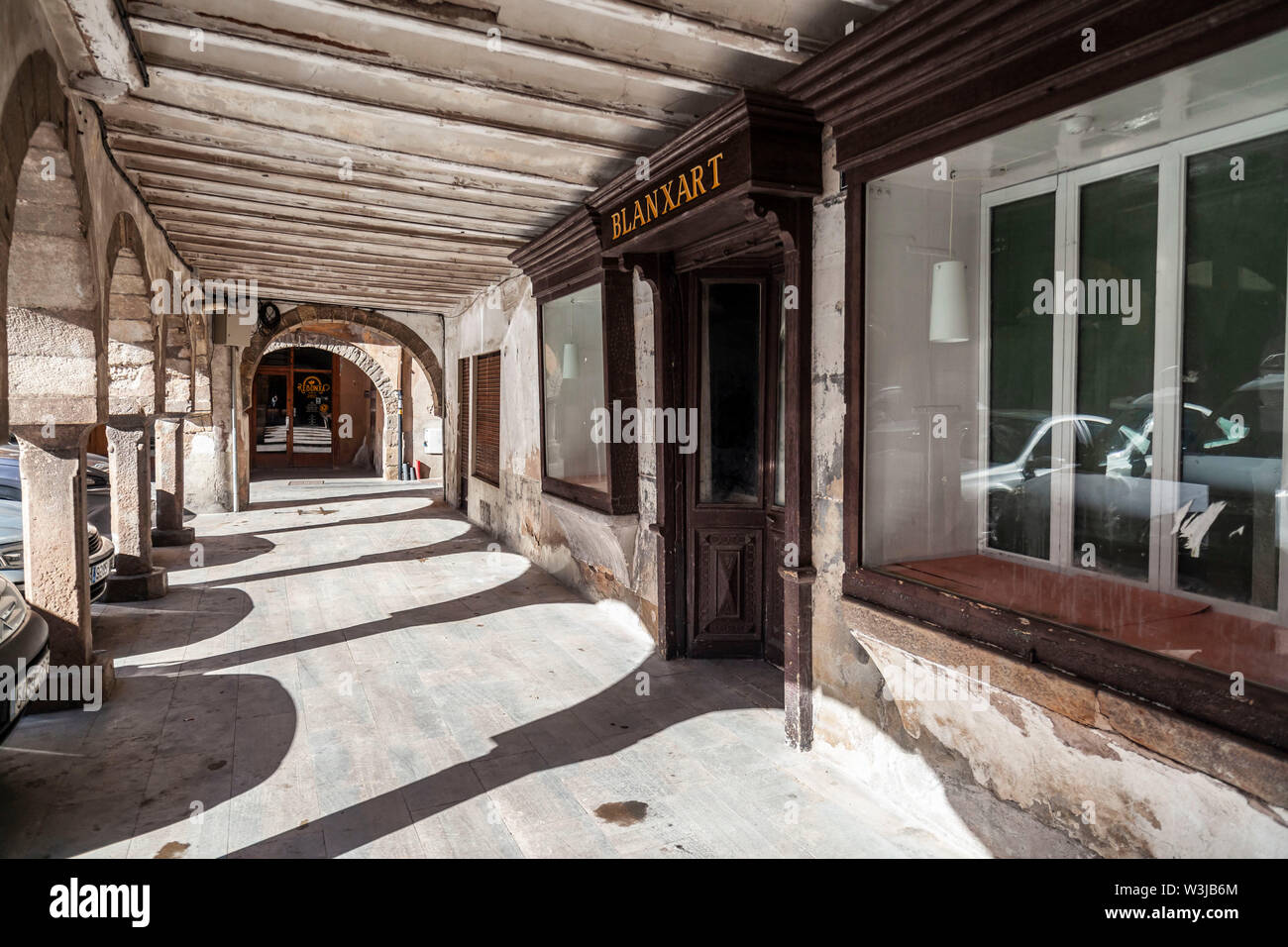 SANT JOAN DE LES ABADESSES,SPAIN- OCTOBER 25,2018: Old arcades in main square village. Stock Photo