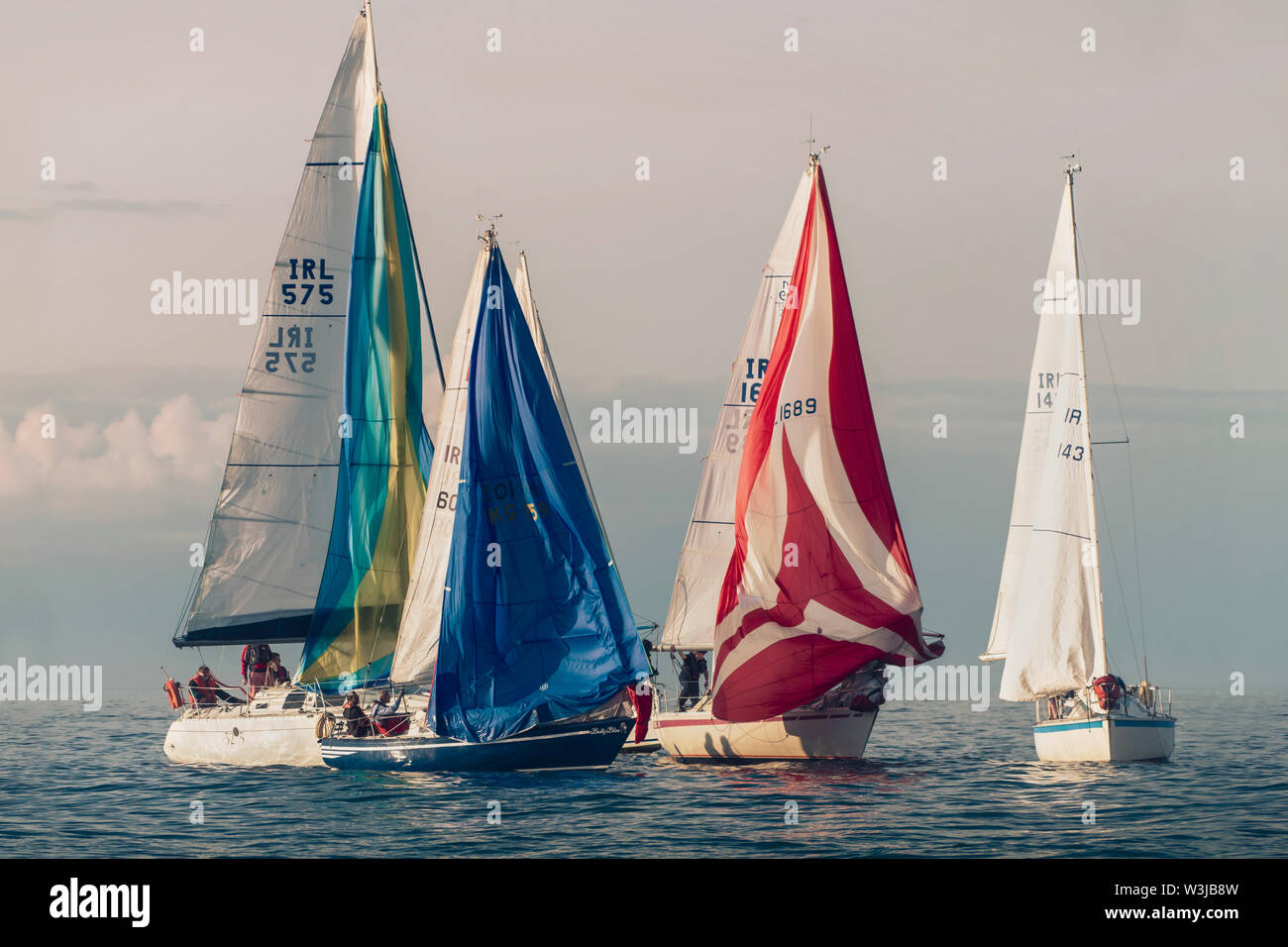 Sailing together. Group of sailboats sailing in a company. Just before