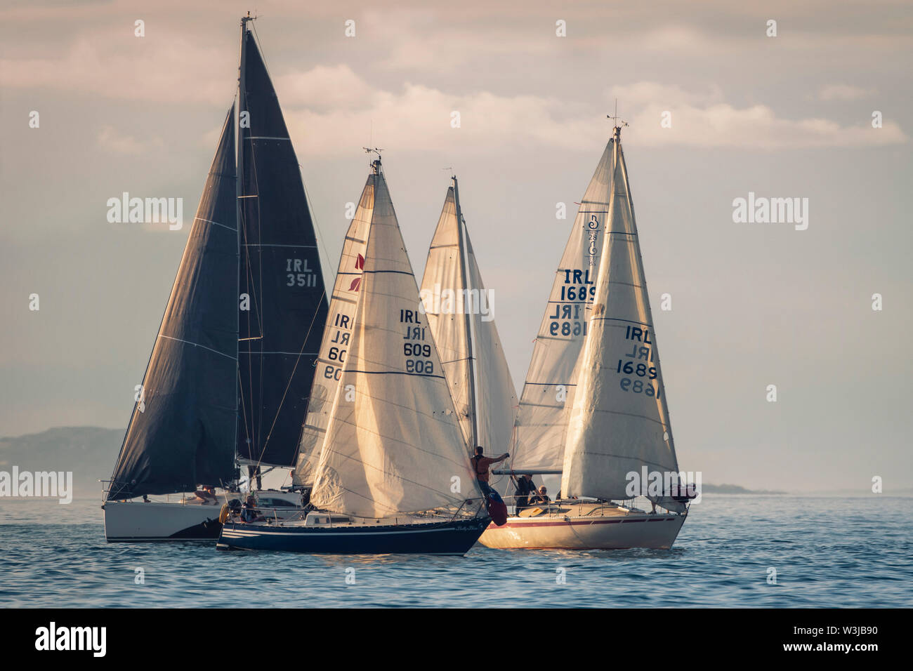 Sailing together. Group of sailboats sailing in a company. Just before