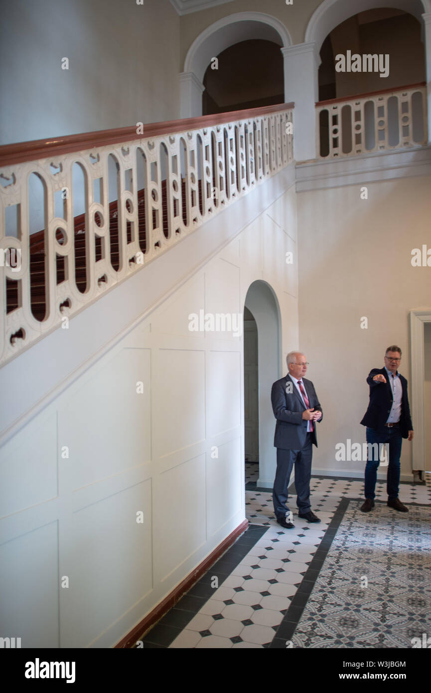 16 July 2019, Saxony-Anhalt, Wittenmoor: Carsten Wulfänger (l, CDU), District Administrator of the Stendal district and Olaf Stehwien (r), Managing Director of the confectionery Stehwien are standing in the Wittenmoor manor house. The businessman plans to move his company headquarters from Tangermünde to the estate in Wittenmoor. The district of Stendal supports the project with funds from the pilot project 'Land(auf)Schwung' of the Federal Ministry of Food and Agriculture. The money will be used to partially renovate the property. A kind of 'chocolate castle' is planned with rooms for events Stock Photo