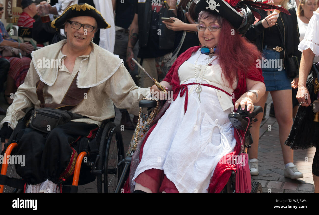 Two wheelchair users taking part in the parade on Pirate Day in July, Hastings, East Sussex, UK Stock Photo