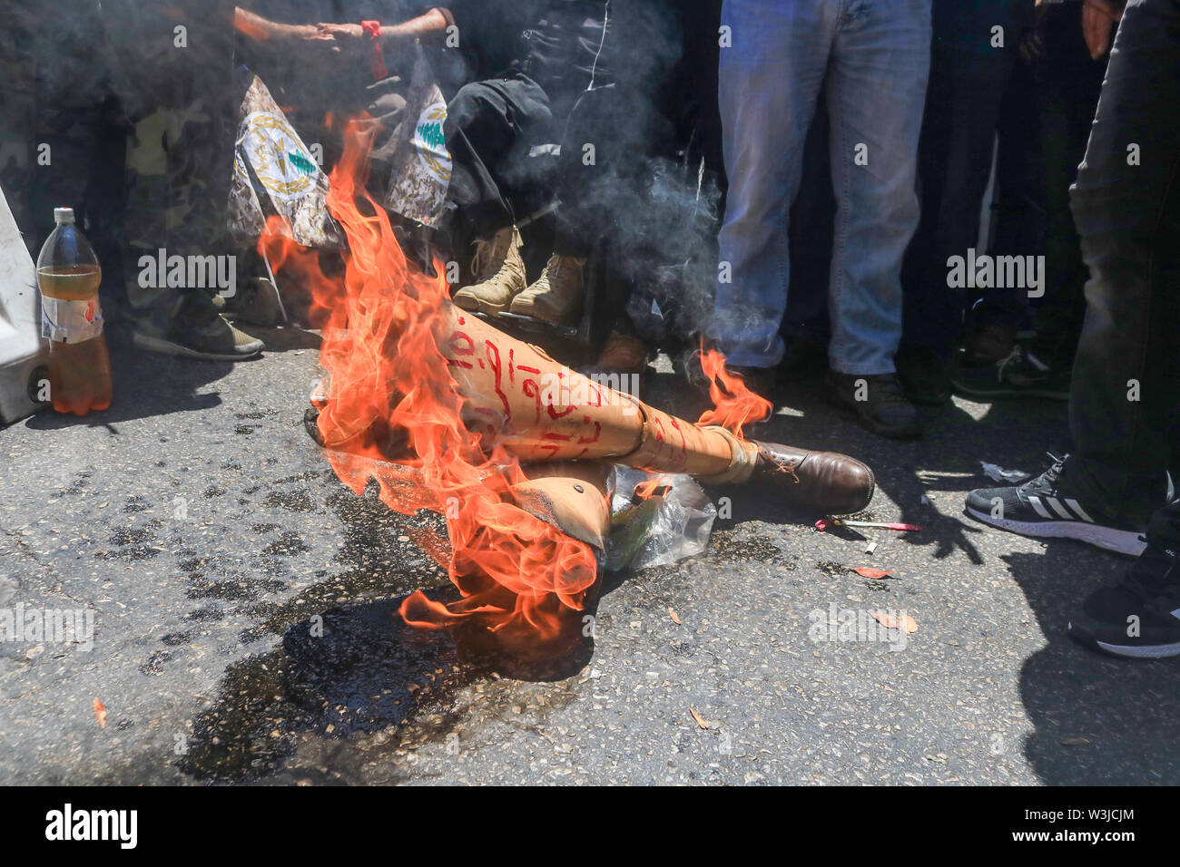 Beirut Lebanon. 16th July 2019. Retired soldiers of the Lebanese  army set fire to a veteran's prosthetic legs as they  protest against cuts in state pensions and over austerity budget measures being debated by in Parliament as  planned cuts have unleashed a wave of public discontent, which have  targeted pensions, wages, services and social benefits.Credit: amer ghazzal/Alamy Live News Stock Photo