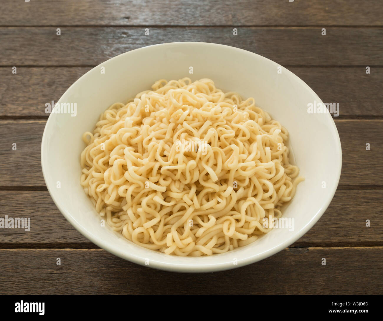 Instant noodles in bowls on wood table Stock Photo Alamy