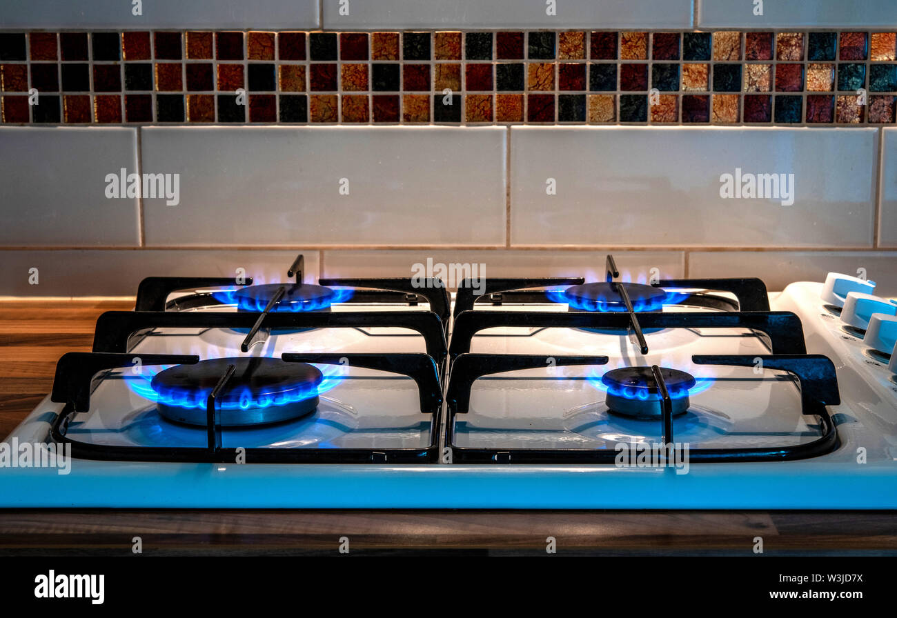 Kitchen gas hob with all four rings alight Stock Photo Alamy