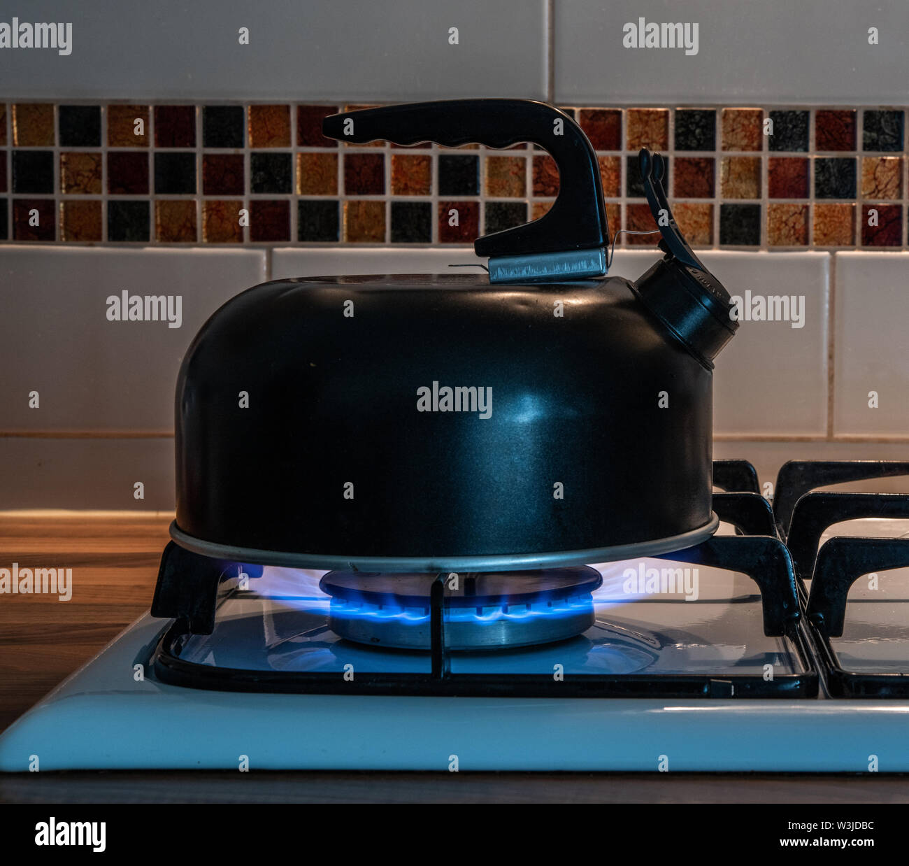 Kettle on a gas hob cooking Stock Photo Alamy