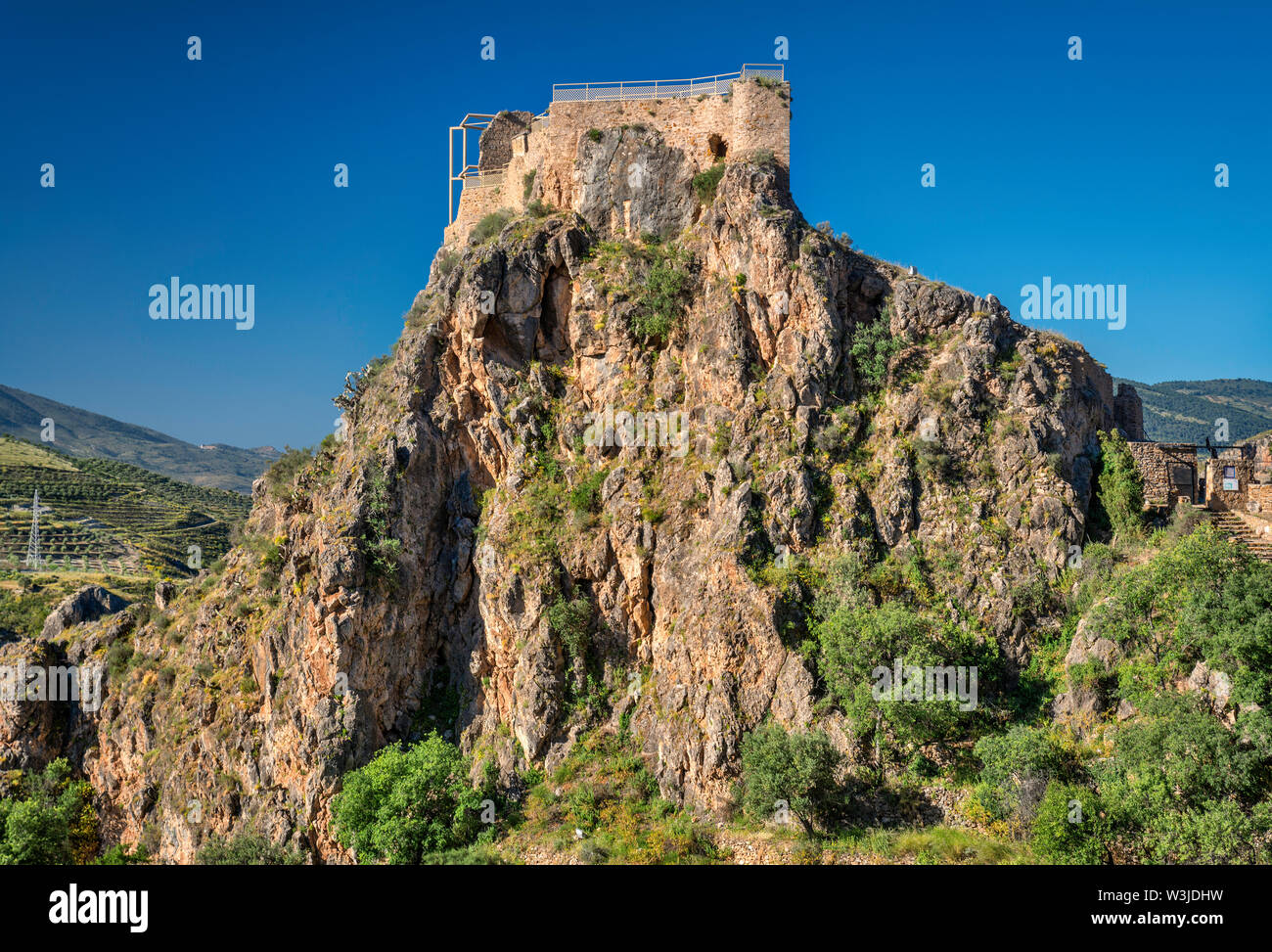 Ruined medieval castle on top of rock in Lanjaron, Las Alpujarras, Granada province, Andalusia, Spain Stock Photo