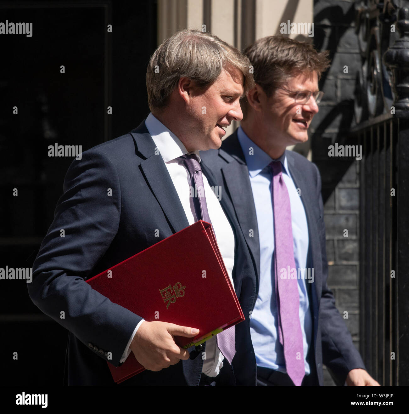 Downing Street, London, UK. 16th July 2019. Government Ministers leave Downing Street after weekly cabinet meeting. Chris Skidmore (left), Minister of State for Universities, Science, Research and Innovation, leaves with Greg Clark, Business and Energy Secretary. Credit: Malcolm Park/Alamy Live News. Stock Photo