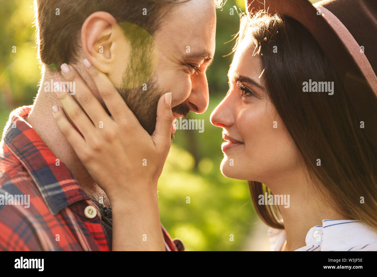 Image of a cute pleased romantic young loving couple walking outdoors in a green nature park forest kissing Stock Photo - Alamy Image of a cute pleased romantic young loving couple walking outdoors in a green nature park forest kissing Stock Photo - Alamy