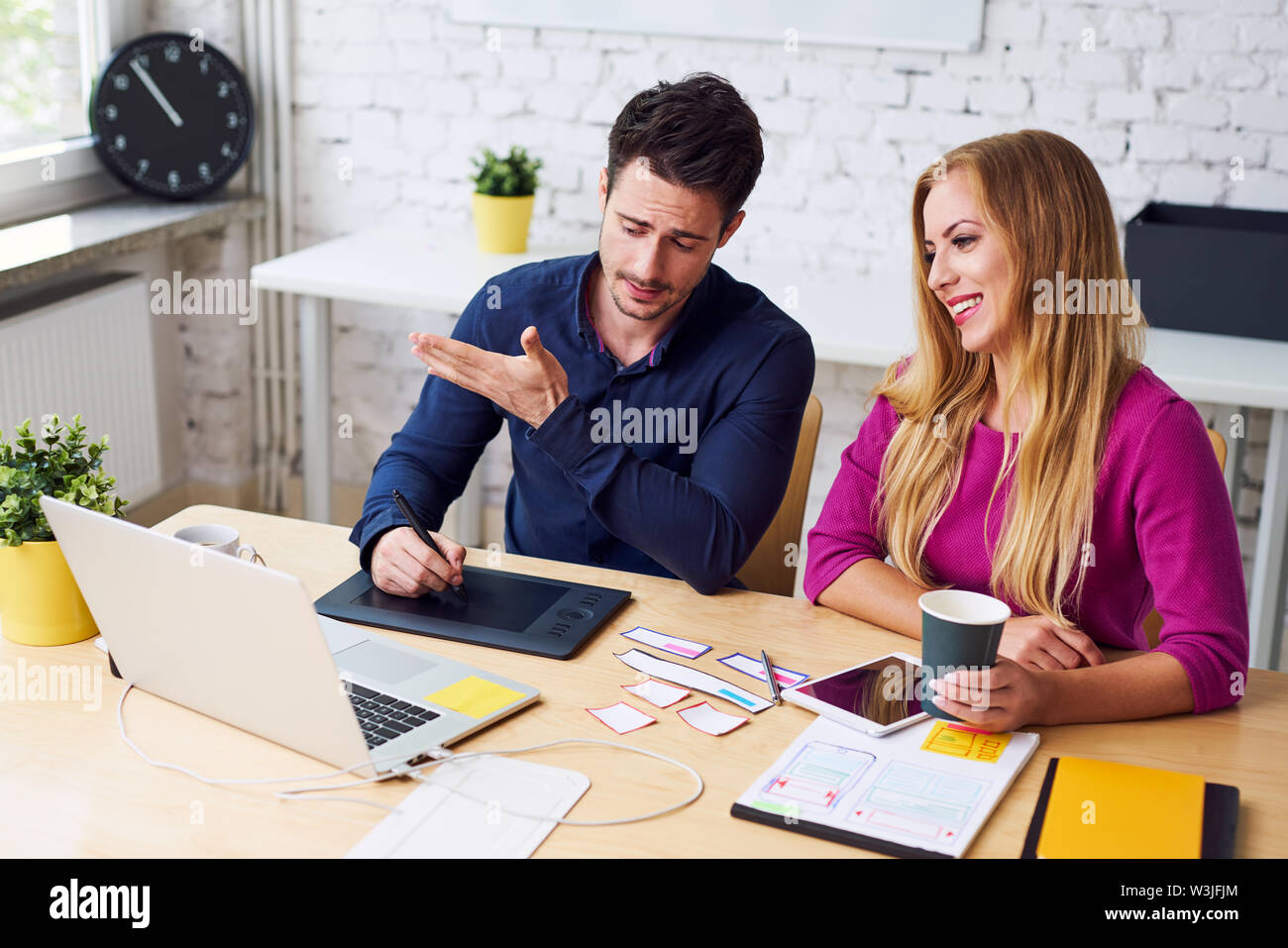 Two web designers prototyping website discussing new ideas Stock Photo