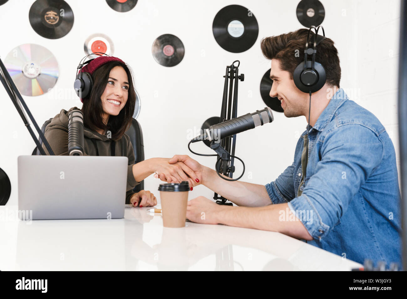 Image of a handsome young man radio host with colleague woman at the  workspace with microphone and sound equipment talking with each other Stock  Photo - Alamy