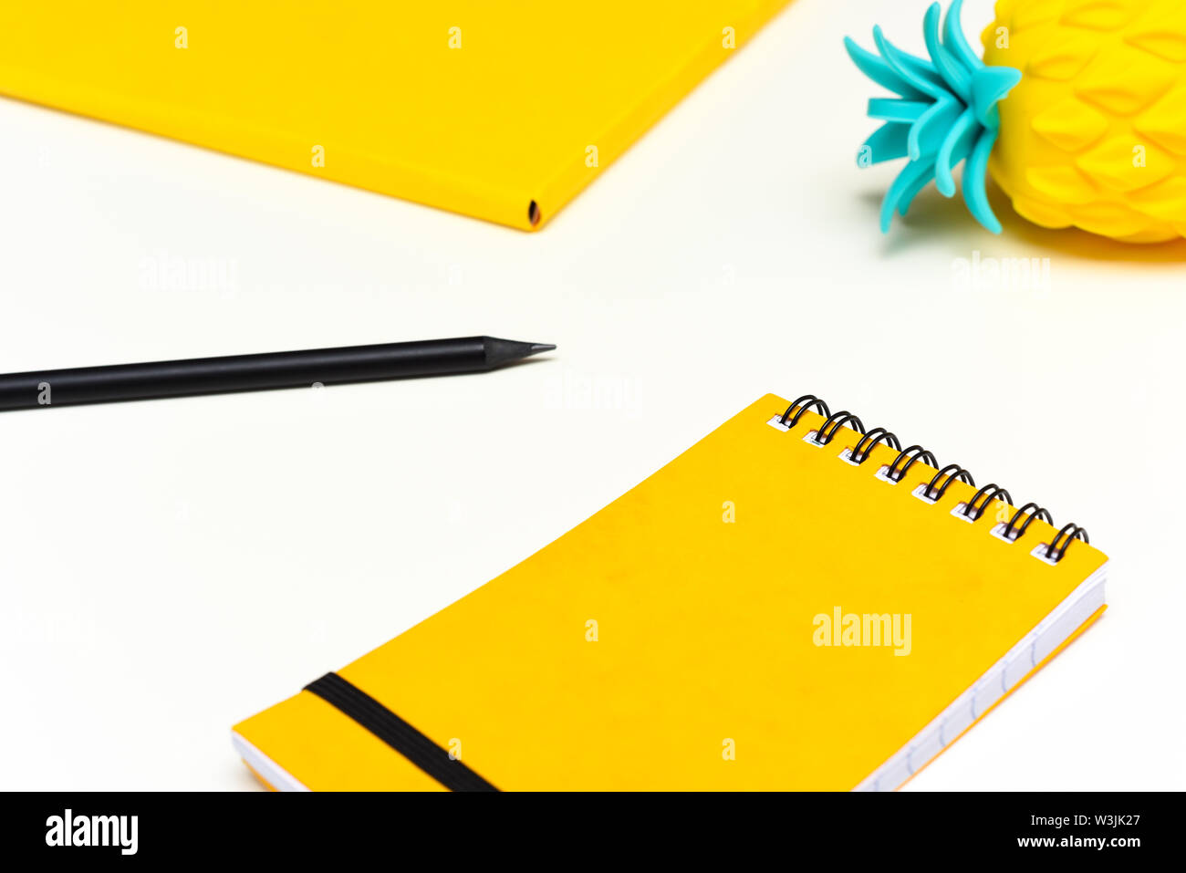 Top view image of office supplies or school accessories, trendy yellow colour objects shot from overhead Stock Photo