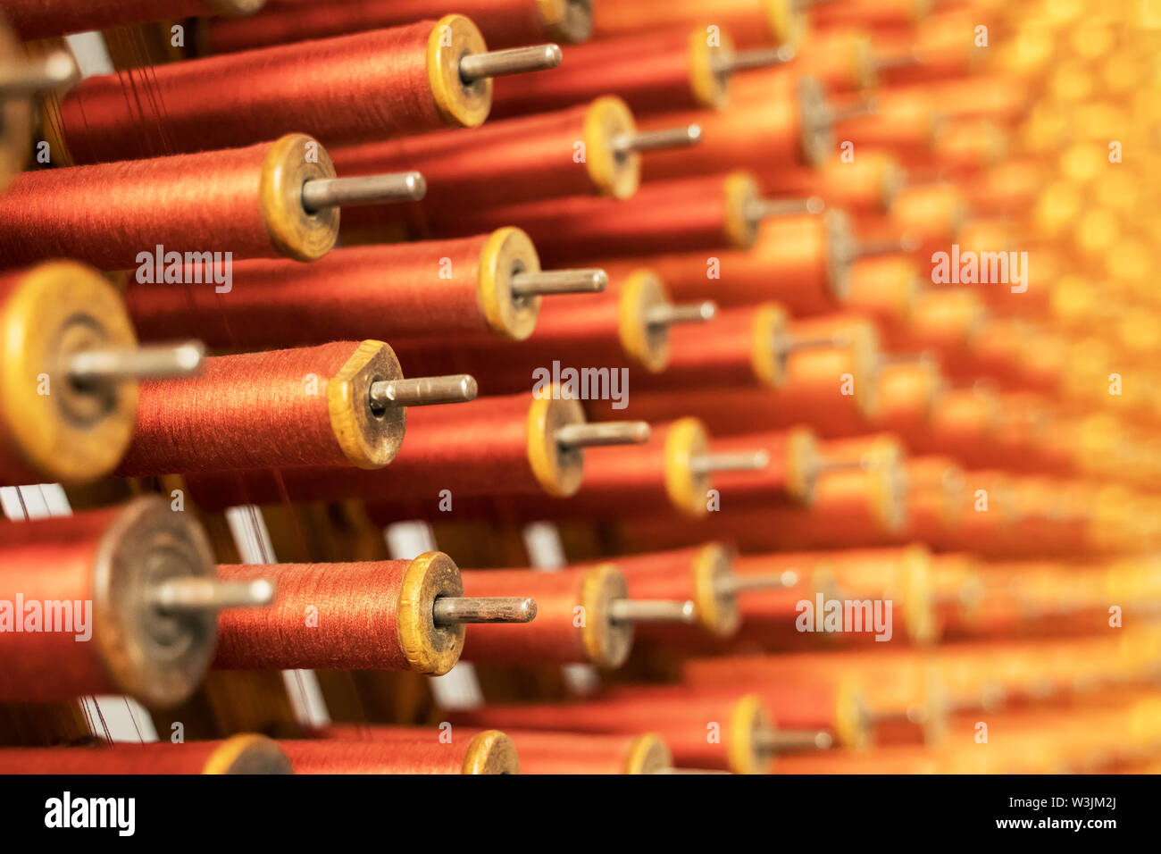 Many multi-colored spool of threads in a sewing factory Stock Photo - Alamy