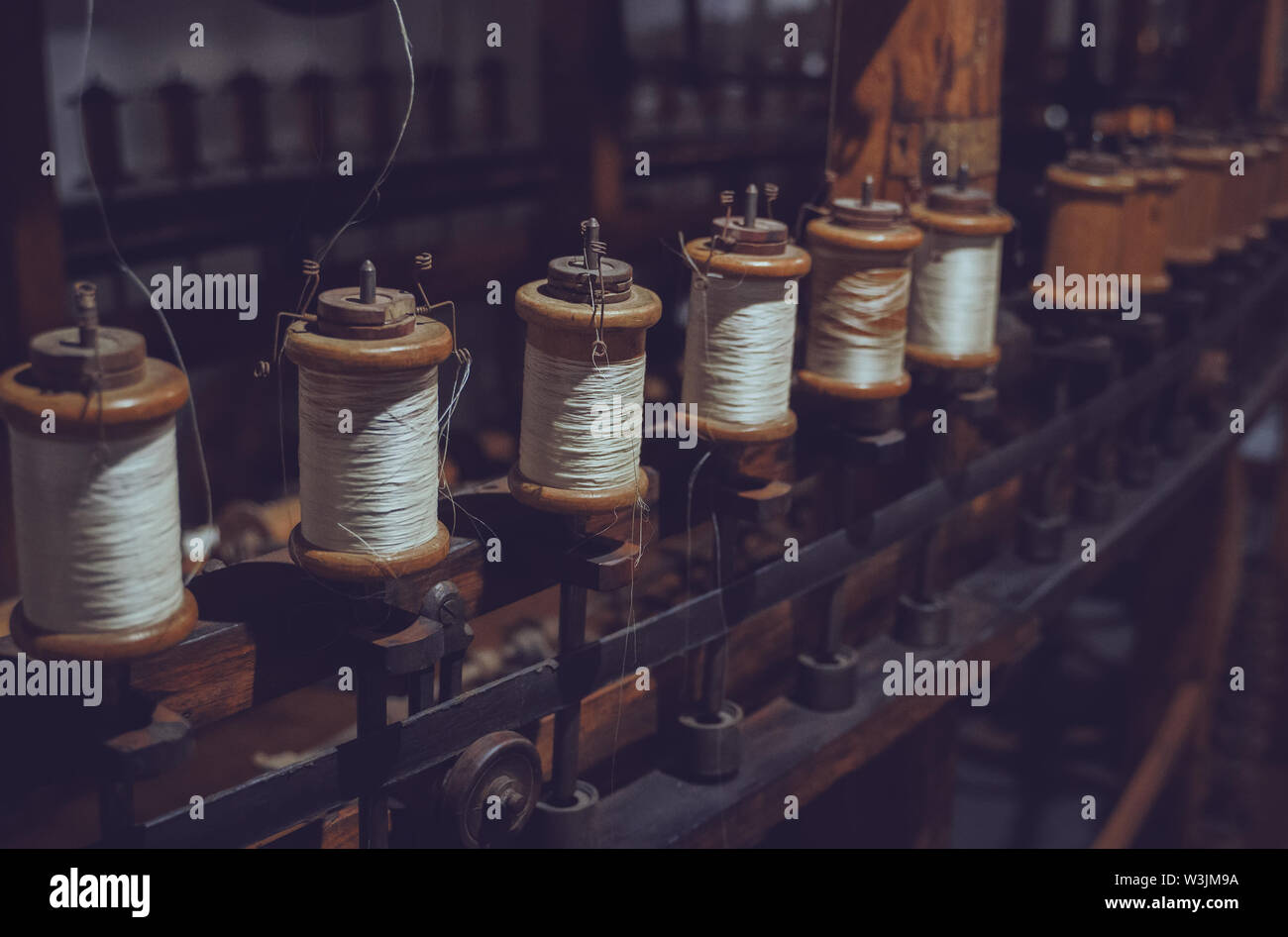 Many white spool of threads in a sewing factory Stock Photo - Alamy