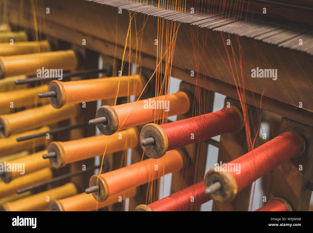Many multi-colored spool of threads in a sewing factory Stock Photo - Alamy