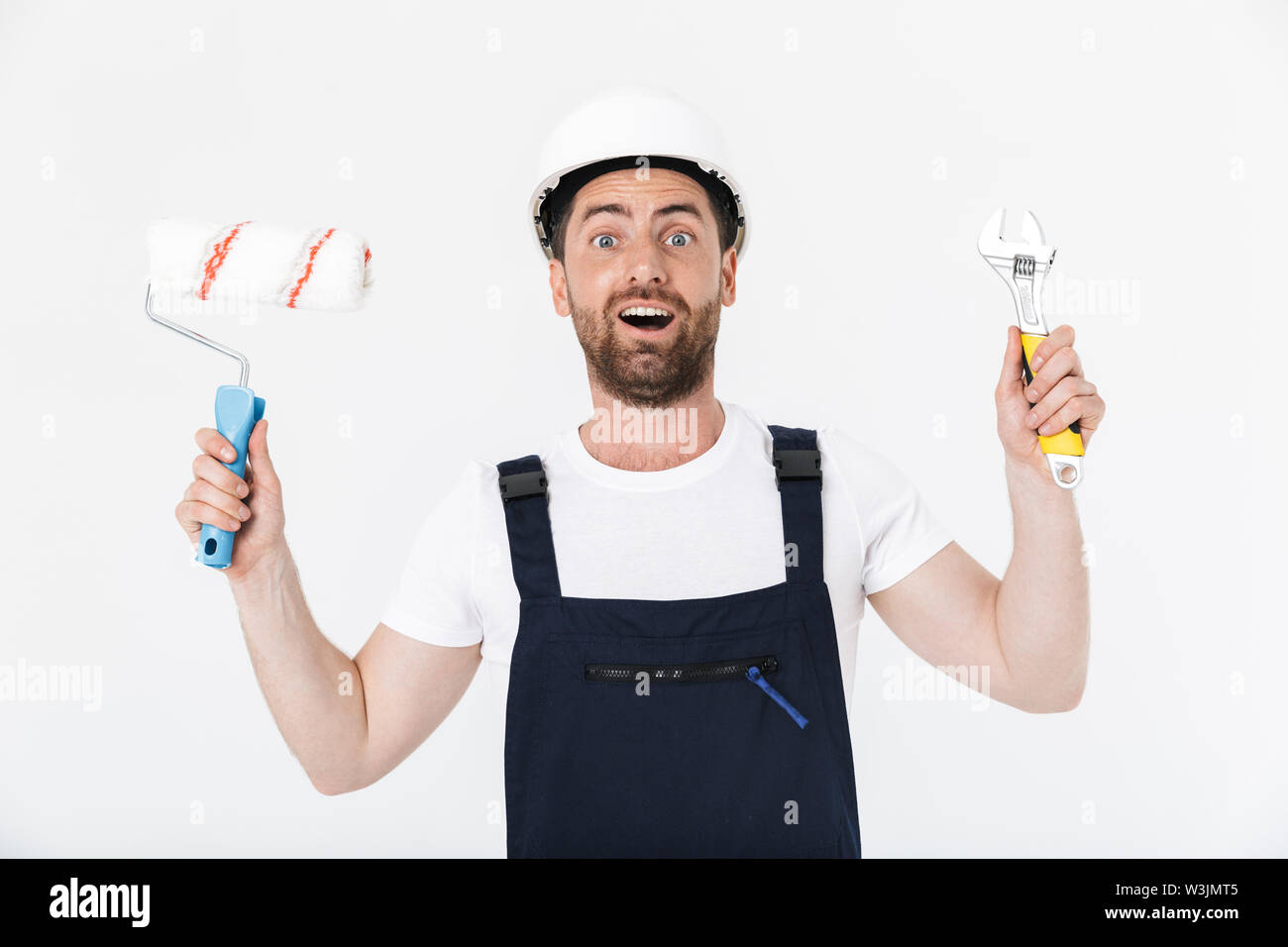 Confident Bearded Builder Man Wearing Overalls And Hardhat