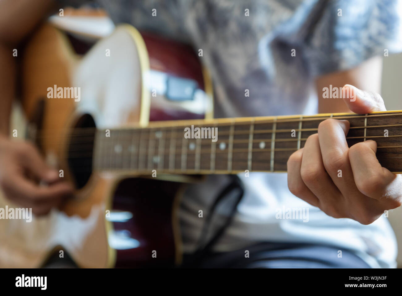 musician plaing acoustic guitar close-up playing chord for jazz rock music Stock Photo