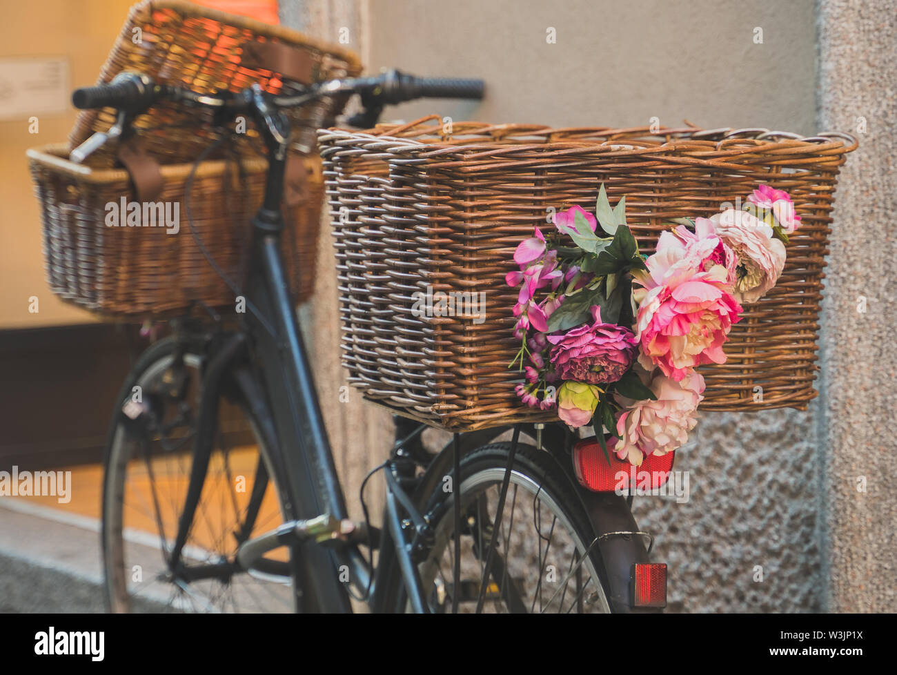 Retro bicycle with baskets parked near the wall Stock Photo Alamy