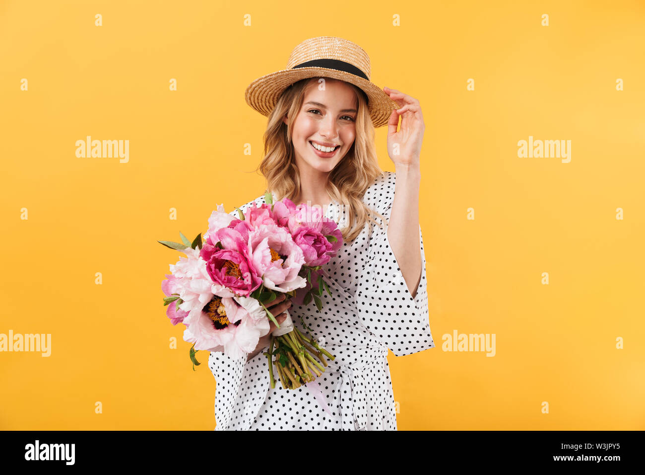 Beautiful young blonde woman wearing summer dress and straw hat ...