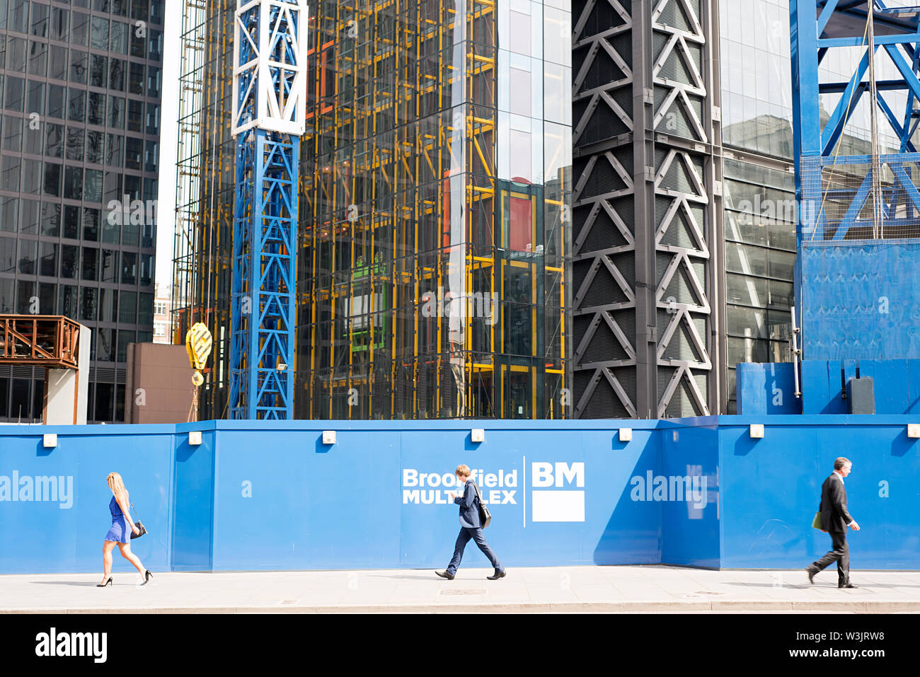 office workers walking with a skyscraper building site background Stock Photo