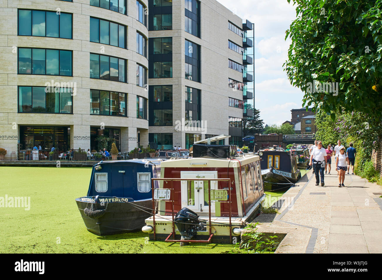 The Regents Canal at King's Cross, London UK, with narrowboats and new apartment buildings Stock Photo