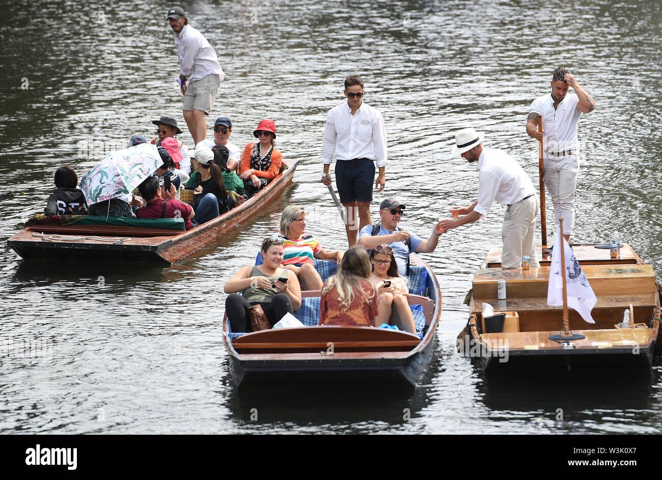 People buy drinks as they punt along the River Cam in Cambridge, as more hot weather is due to hit the UK this week. Stock Photo