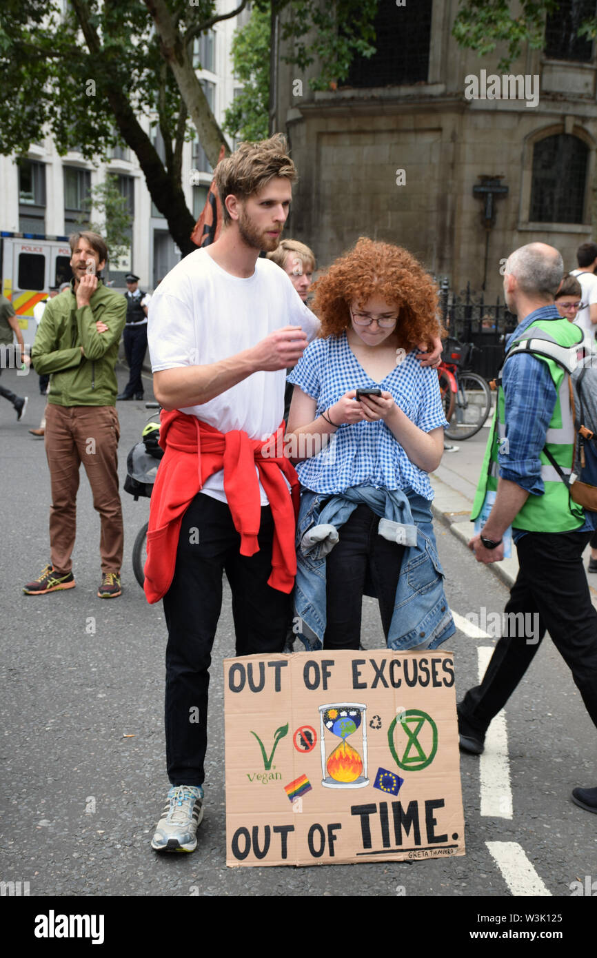 Extinction Rebellion protest outside Royal Courts of Justice in London, blocking the road. The group is campaigning for the government to declare a cl Stock Photo