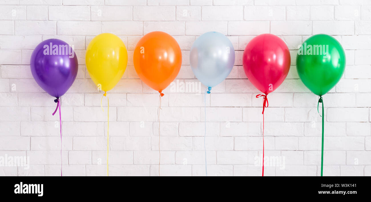 Set of colorful helium balloons for party celebration on white Stock Photo