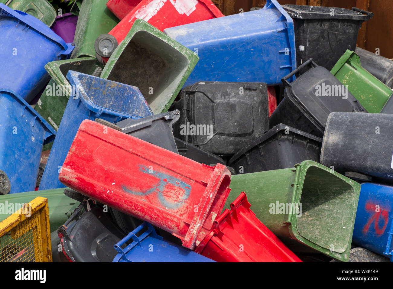 Colorful trash cans. Many plastic garbage cans on the waste waiting to