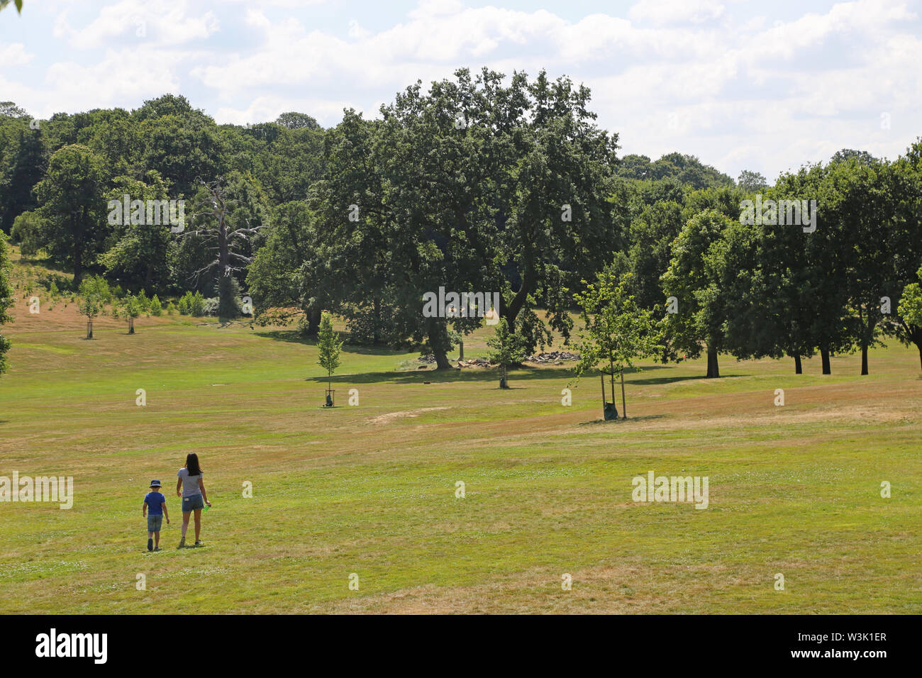 A woman and child walk in Beckenham Place Park, south London, UK. The newly landscaped grounds opened in 2019 return the park to it's original layout. Stock Photo
