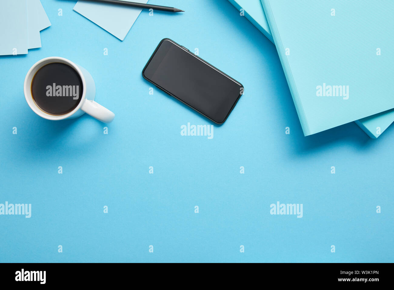 Top view of smartphone with blank screen and cup of coffeee at ...