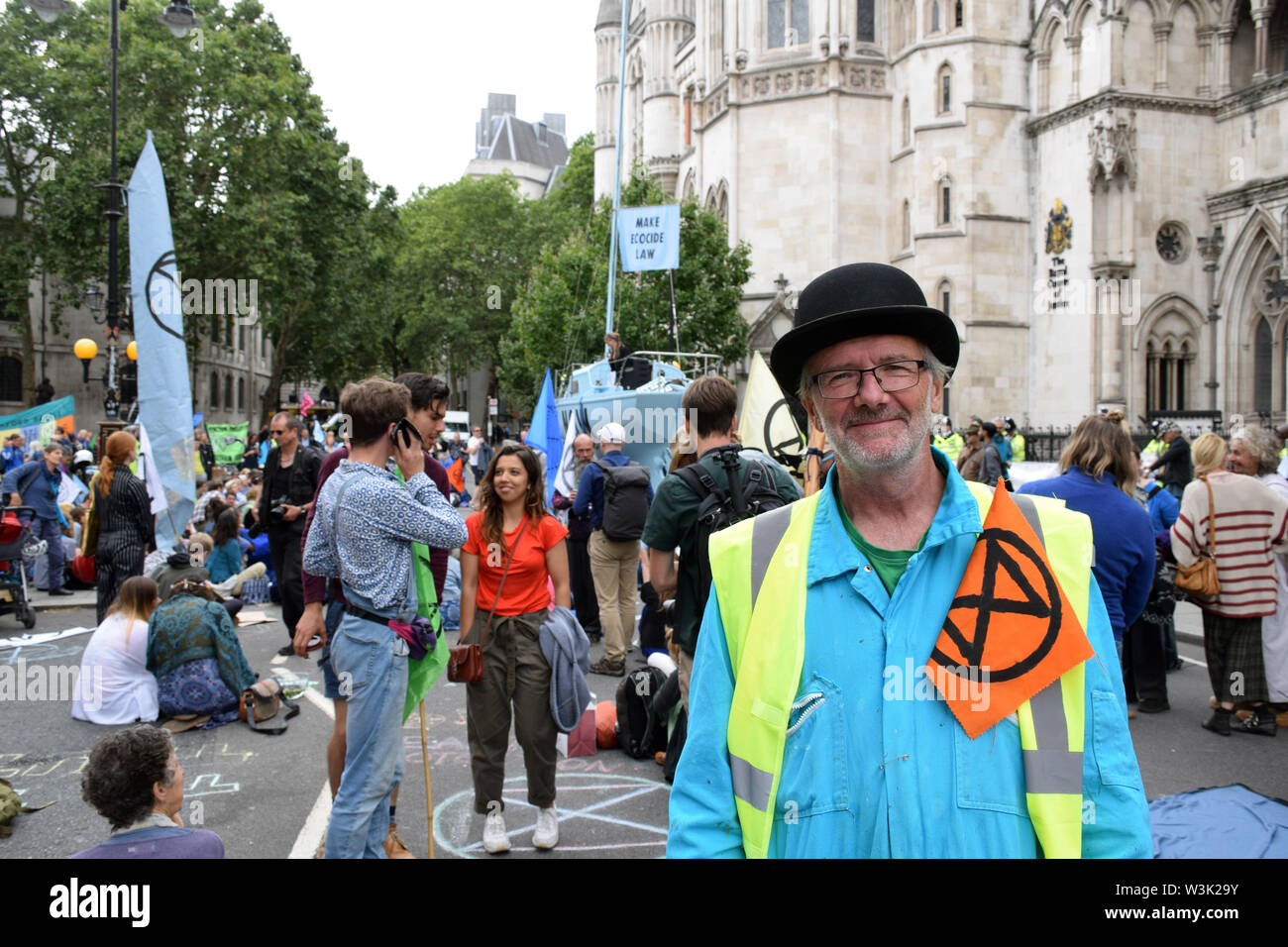 Extinction Rebellion protest outside Royal Courts of Justice in London, blocking the road. The group is campaigning for the government to declare a cl Stock Photo