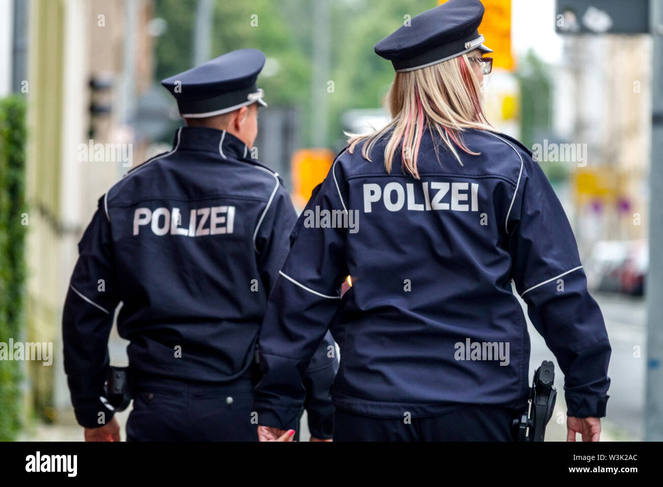 Germany Police Officer woman Two police patrol Germany policeman police officers rear view german policewoman Stock Photo