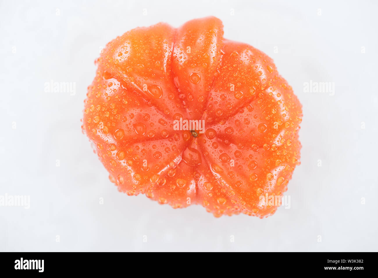 top view of red ripe tomato with water drops isolated on white Stock ...